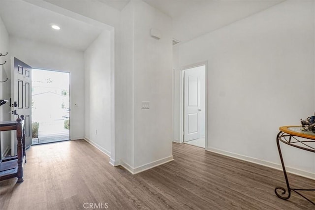 foyer entrance featuring dark wood finished floors and baseboards