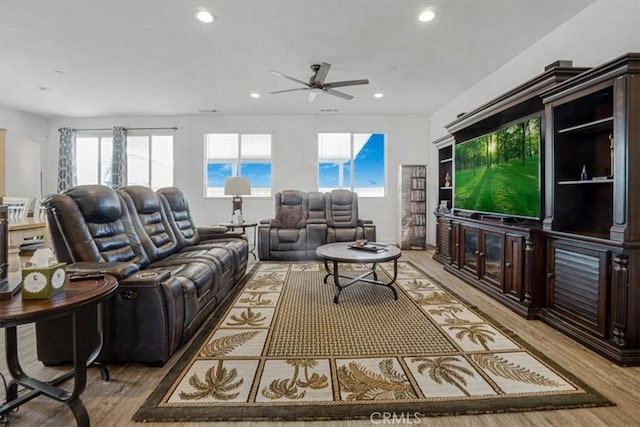 living area with a ceiling fan, recessed lighting, and wood finished floors