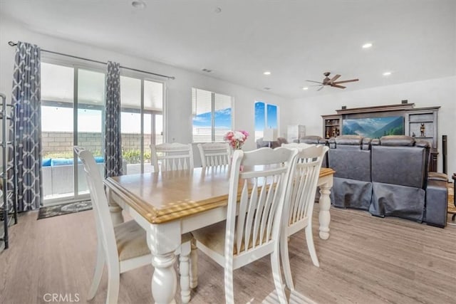 dining room with a ceiling fan, recessed lighting, and light wood-style flooring