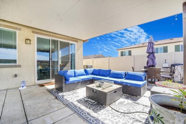 view of patio with outdoor lounge area and fence