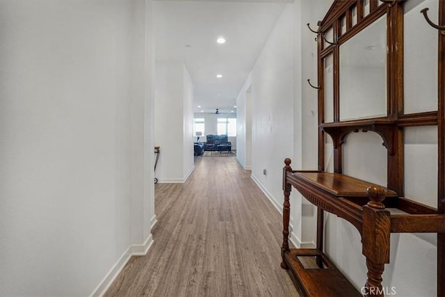 corridor with recessed lighting, baseboards, and wood finished floors