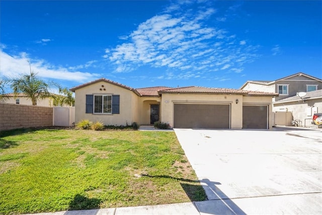 mediterranean / spanish home with stucco siding, fence, a garage, driveway, and a front lawn