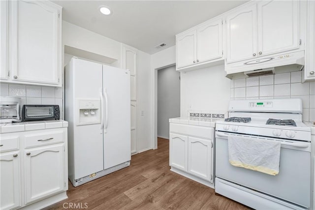 kitchen featuring light hardwood / wood-style flooring, white appliances, tile counters, and white cabinets