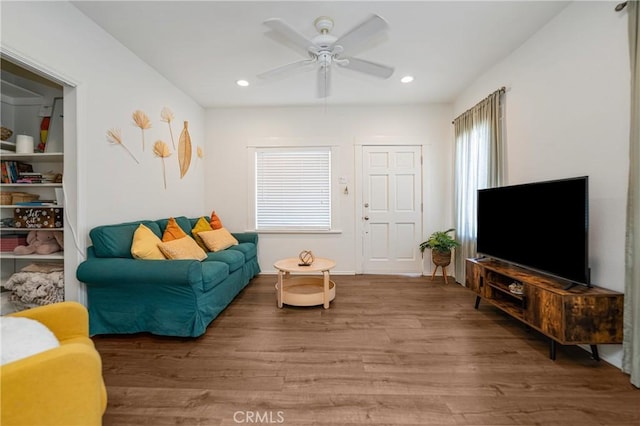 living room featuring hardwood / wood-style flooring and ceiling fan