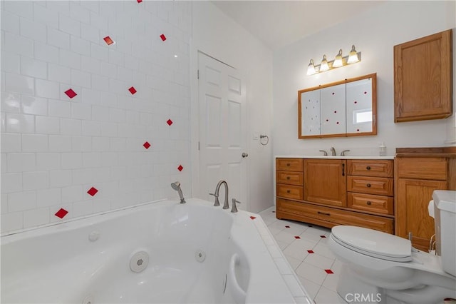 bathroom featuring vanity, toilet, tile patterned flooring, and a bath