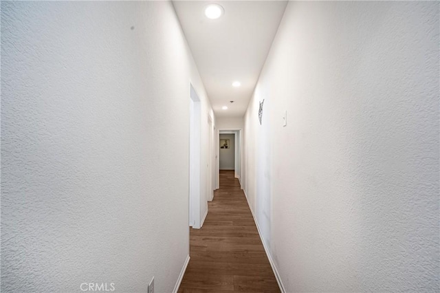 hallway with dark hardwood / wood-style floors