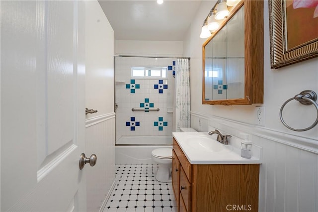 full bathroom with vanity, tiled shower / bath combo, tile patterned floors, and toilet