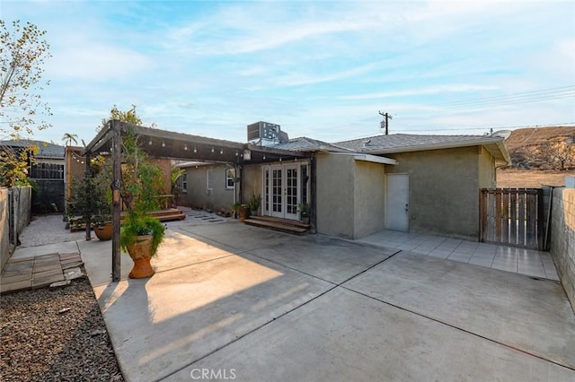 back of house with french doors and a patio area