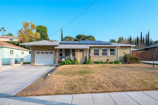 ranch-style house featuring a garage, a front lawn, solar panels, and covered porch