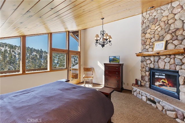 bedroom with wood ceiling, a stone fireplace, and an inviting chandelier