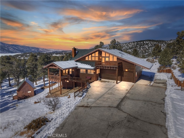 view of front of property with a garage and a mountain view