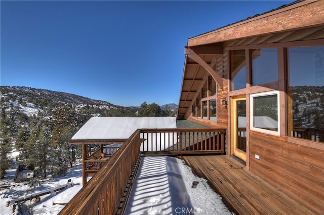 snow covered deck featuring a mountain view