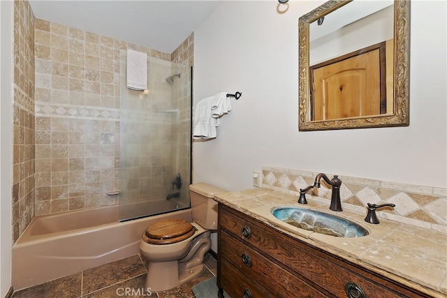 full bathroom with tiled shower / bath, vanity, and toilet