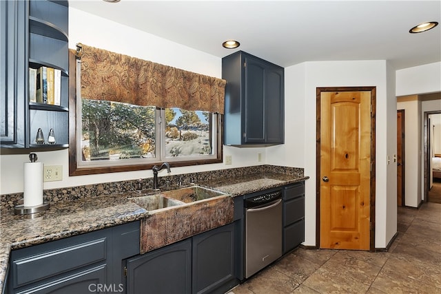 kitchen with dishwasher, sink, and dark stone countertops