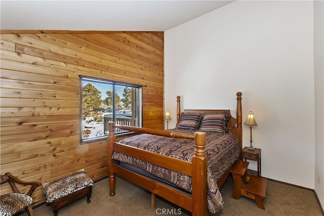 carpeted bedroom with wooden walls