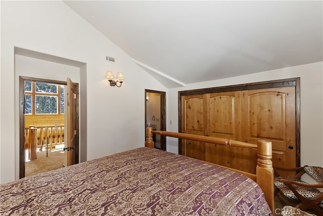 carpeted bedroom with lofted ceiling