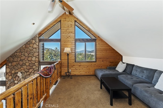 additional living space featuring vaulted ceiling with beams, carpet floors, and wooden walls