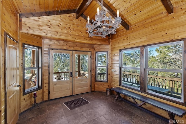 interior space with vaulted ceiling with beams, wood ceiling, french doors, and wood walls