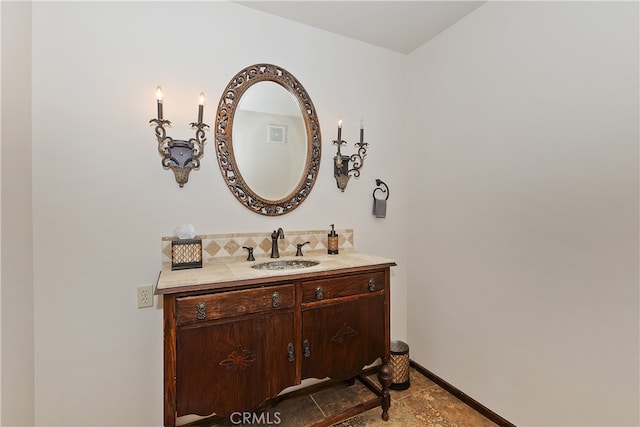 bathroom featuring vanity and backsplash