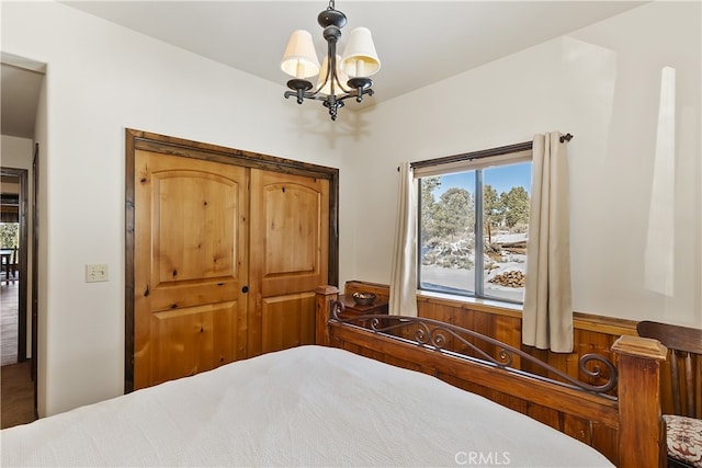 bedroom featuring a notable chandelier