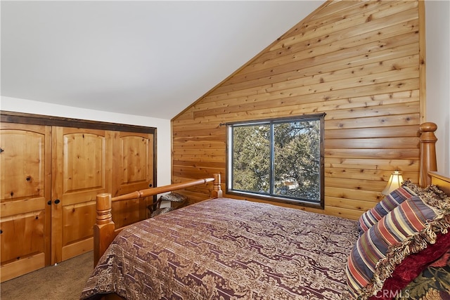 bedroom featuring carpet floors, wooden walls, and vaulted ceiling