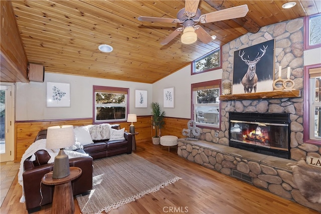 living room with wood ceiling, a healthy amount of sunlight, a fireplace, and hardwood / wood-style flooring