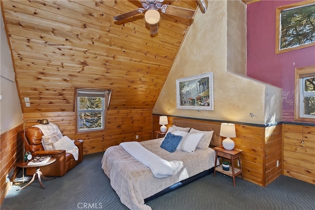 carpeted bedroom featuring vaulted ceiling and wooden walls