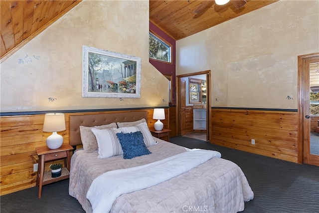 bedroom with wood ceiling, high vaulted ceiling, and dark colored carpet