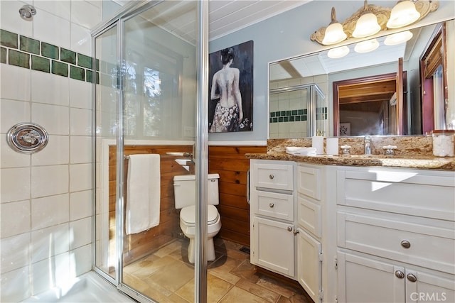 bathroom with vanity, toilet, and a shower with shower door