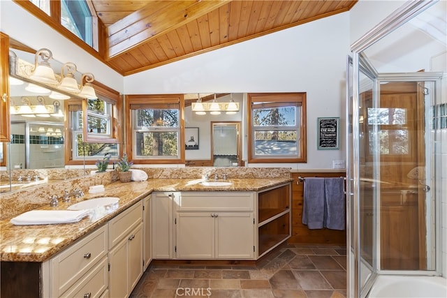 bathroom featuring wood ceiling, lofted ceiling, vanity, and a shower with door