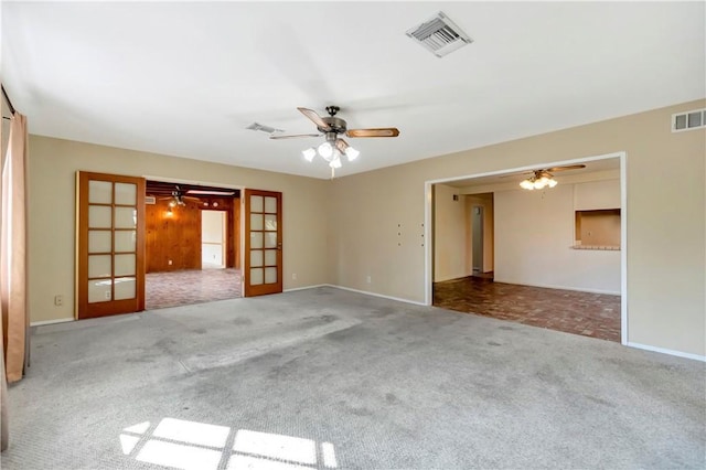 unfurnished room with french doors, ceiling fan, and carpet flooring