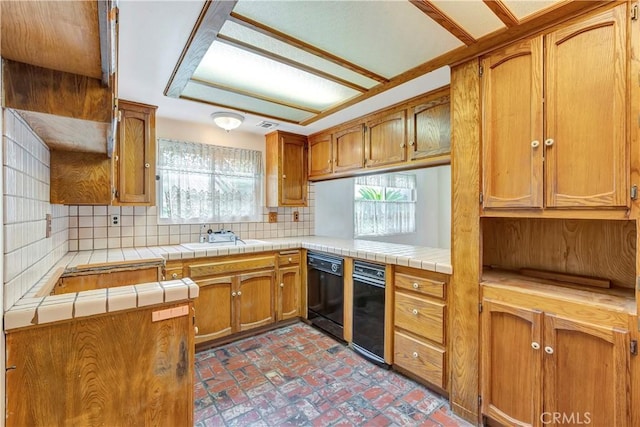 kitchen featuring tile countertops, dishwasher, sink, decorative backsplash, and kitchen peninsula