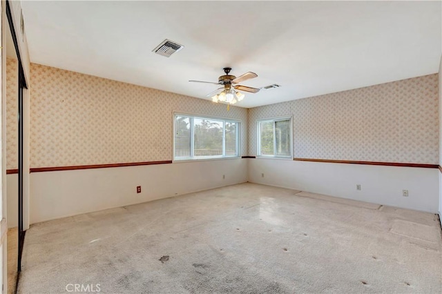 spare room featuring ceiling fan and light colored carpet