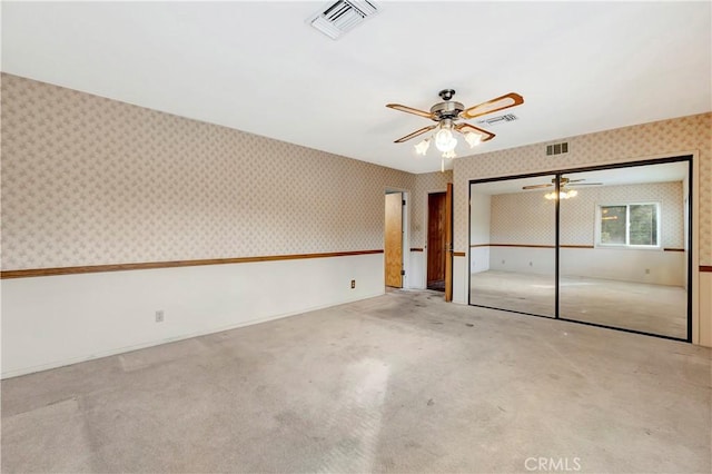 interior space featuring light carpet, ceiling fan, and a closet