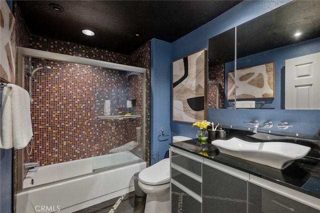 full bathroom featuring vanity, tile patterned flooring, enclosed tub / shower combo, and toilet