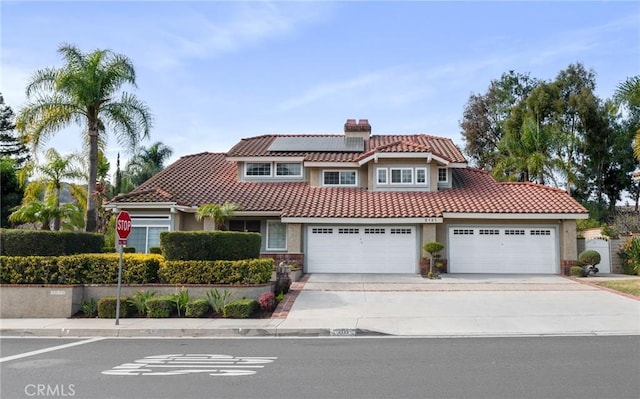 mediterranean / spanish-style house with solar panels