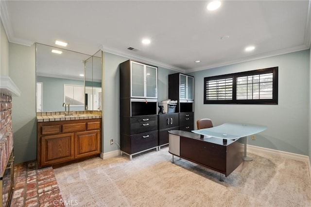 office with crown molding, sink, and light carpet