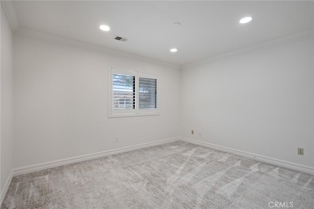 spare room featuring crown molding and carpet floors