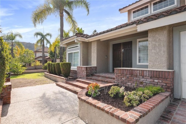 doorway to property with a patio