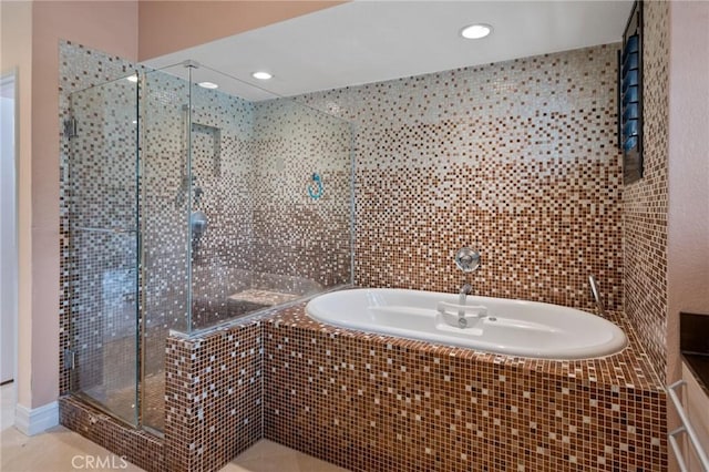 bathroom featuring tile patterned flooring and independent shower and bath