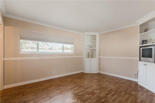 interior space featuring built in shelves, dark wood-type flooring, and ornamental molding