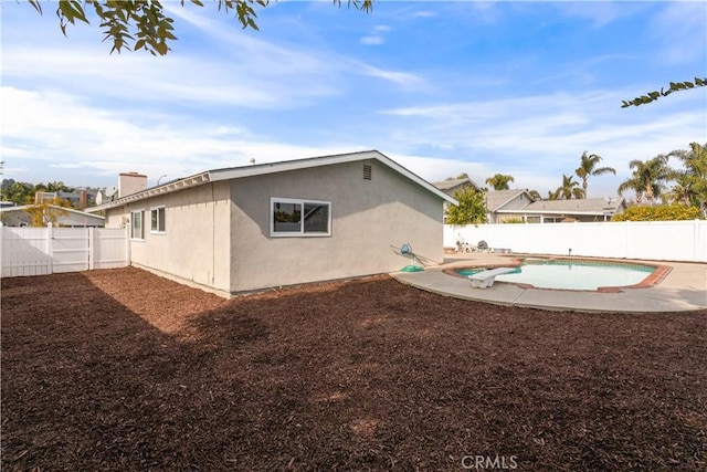 back of house featuring a fenced in pool and a patio area