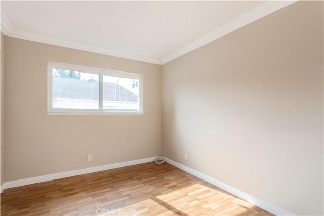 unfurnished room with crown molding and light wood-type flooring