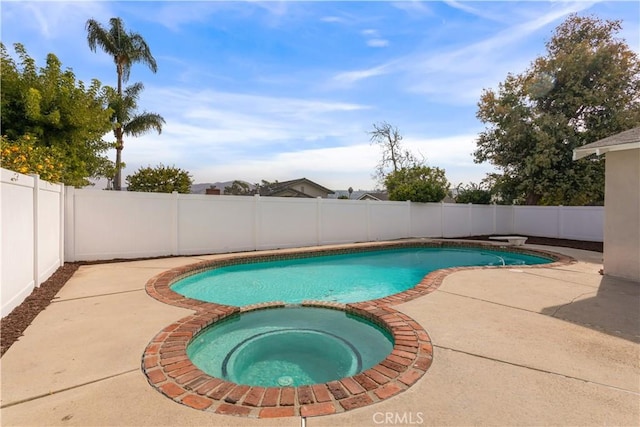 view of swimming pool with an in ground hot tub and a patio