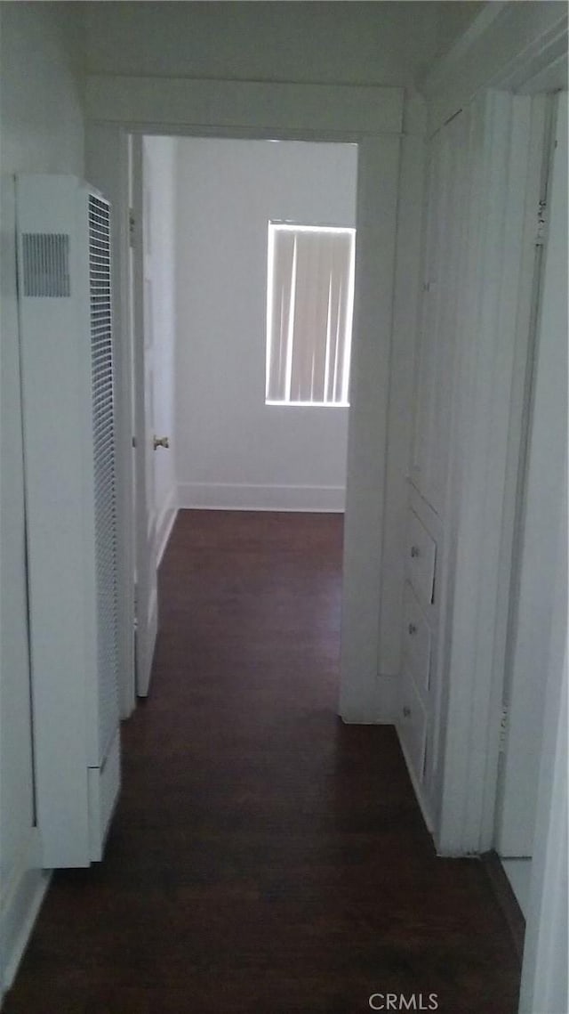 corridor with dark hardwood / wood-style floors