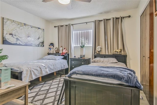 bedroom with ceiling fan, a closet, and a textured ceiling