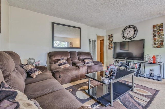 carpeted living room featuring a textured ceiling