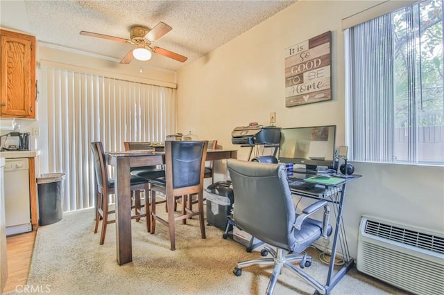 home office with ceiling fan, an AC wall unit, a textured ceiling, and light hardwood / wood-style flooring