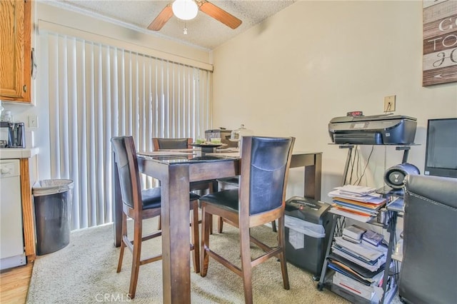 dining space with a textured ceiling, light hardwood / wood-style floors, and ceiling fan