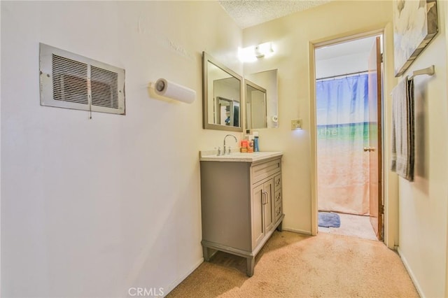 bathroom with vanity, a textured ceiling, and a shower with shower curtain